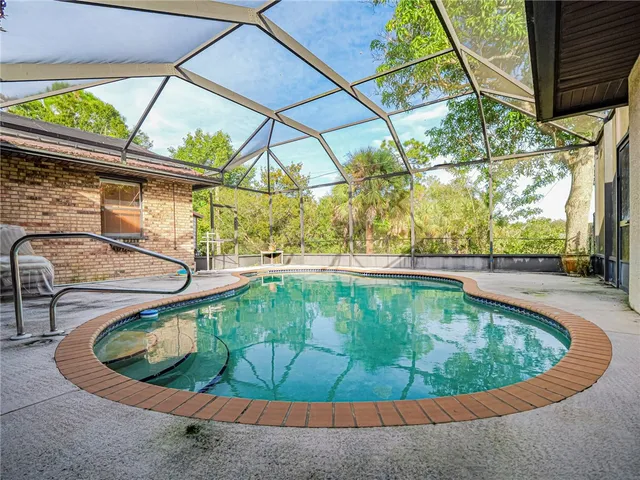 a view of a swimming pool with a yard