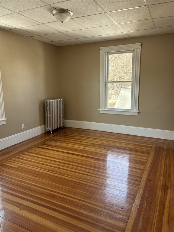 658 Sumner Avenue, Unit 2 Springfield, MA 01108 - Photo 11 of 11 an empty room with wooden floor and windows