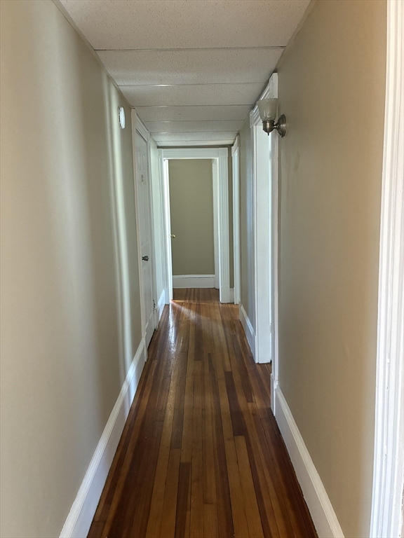 658 Sumner Avenue, Unit 2 Springfield, MA 01108 - Photo 7 of 11 a view of a hallway with wooden floor