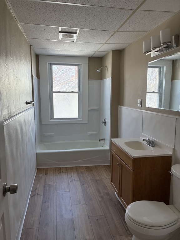 658 Sumner Avenue, Unit 2 Springfield, MA 01108 - Photo 9 of 11 a bathroom with a sink a toilet a mirror and bathtub