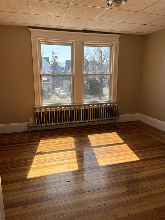 658 Sumner Avenue, Unit 2 Springfield, MA 01108 - Photo 10 of 11 a view of empty room with wooden floor and fan