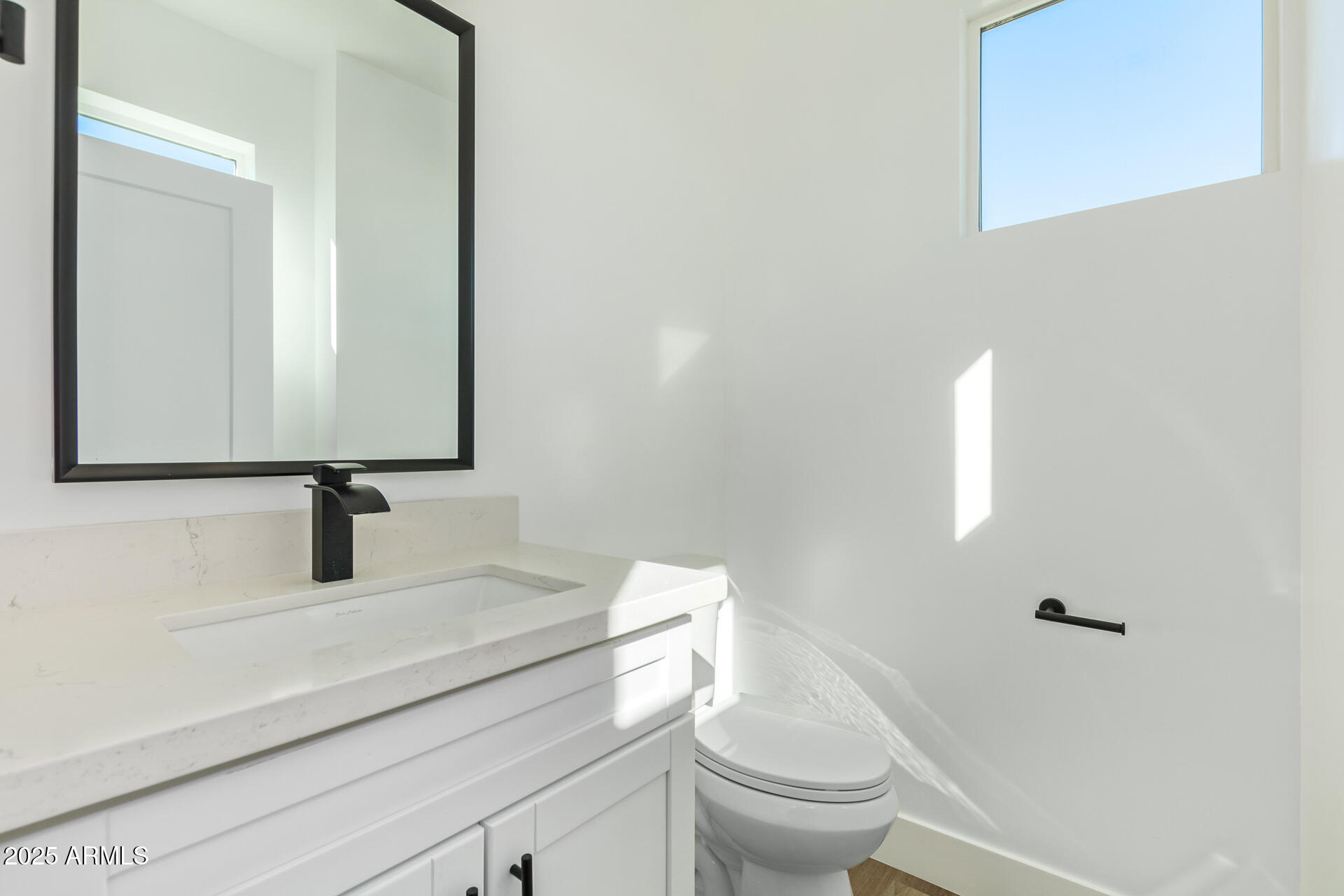 3616 North 12th Street Phoenix, AZ 85014 - Photo 19 of 25 a bathroom with a toilet sink and mirror