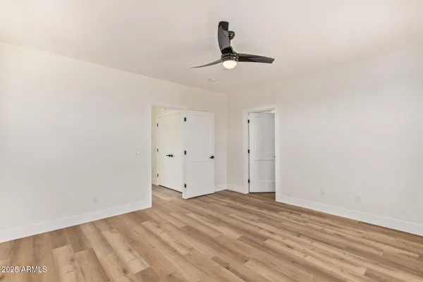 a view of walk in closet with wooden floor