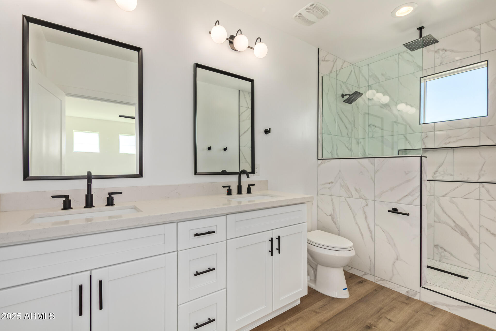 3616 North 12th Street Phoenix, AZ 85014 - Photo 23 of 25 a bathroom with a double vanity sink a toilet and a mirror