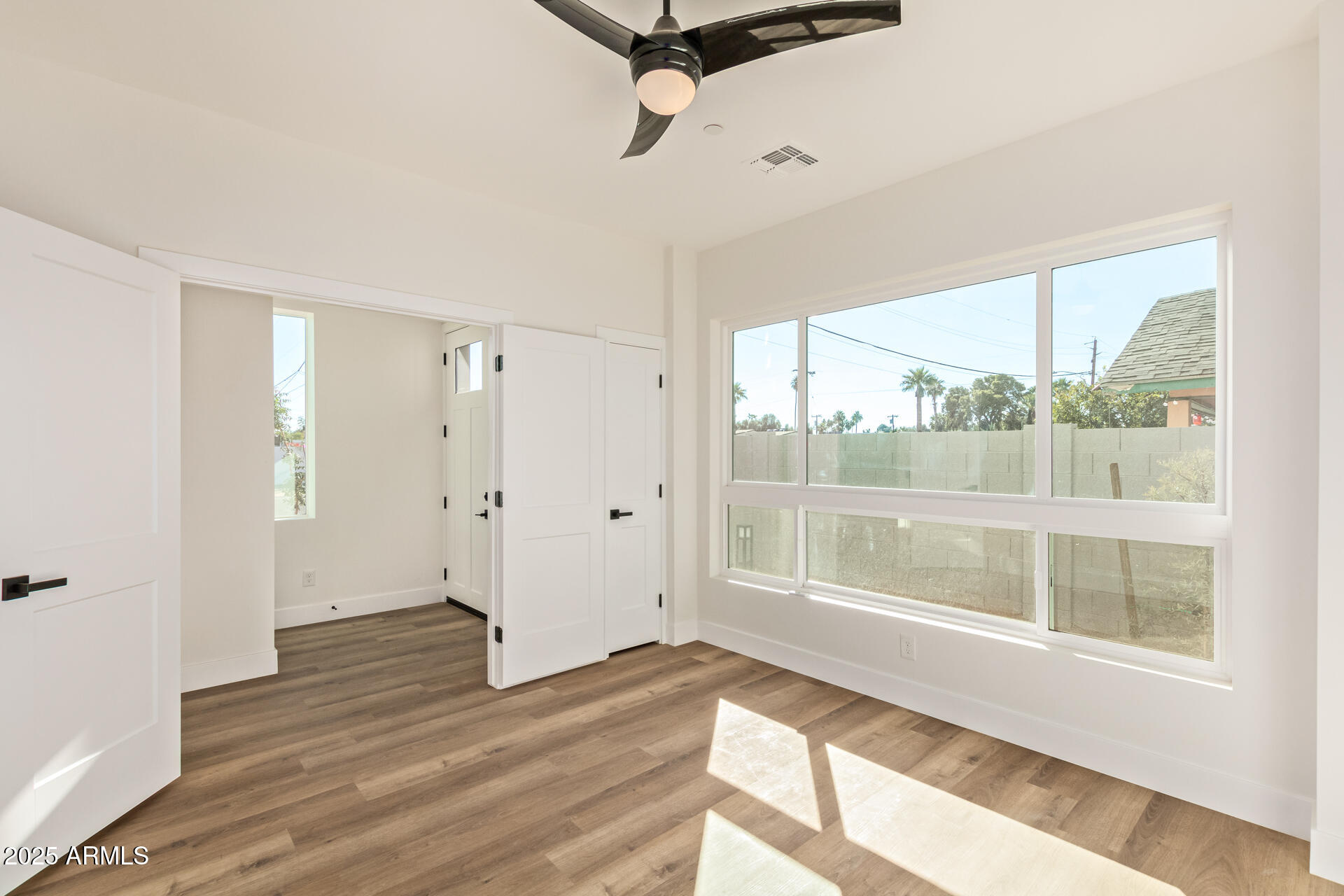 3616 North 12th Street Phoenix, AZ 85014 - Photo 8 of 25 a view of a room with wooden floor and windows