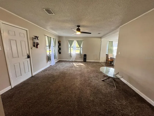 a view of a livingroom with furniture and a window