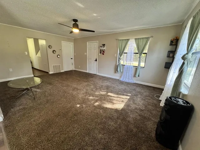a view of a livingroom with furniture and a window