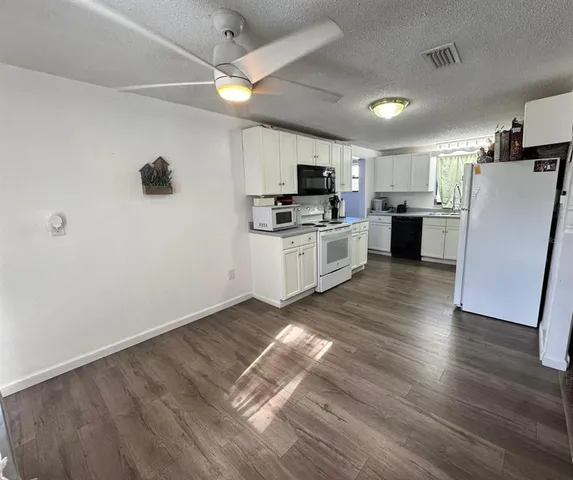 a kitchen with a refrigerator a stove top oven a sink and dishwasher