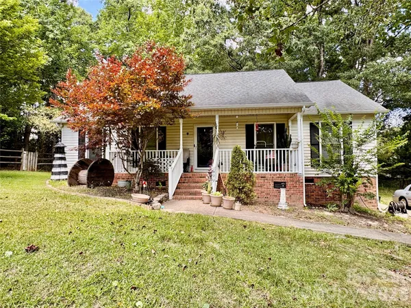 a view of a house with backyard porch and sitting area