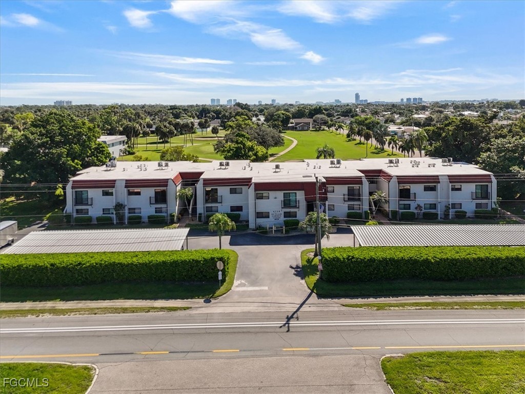 4728 Orange Grove Boulevard, Unit 8 North Fort Myers, FL 33903 - Photo 1 of 31 a front view of a house with a garden