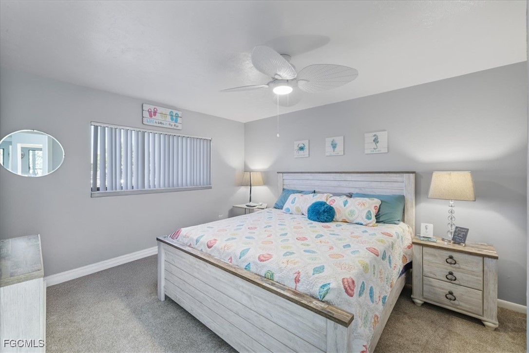 4728 Orange Grove Boulevard, Unit 8 North Fort Myers, FL 33903 - Photo 15 of 31 a bedroom with a bed and a night stand