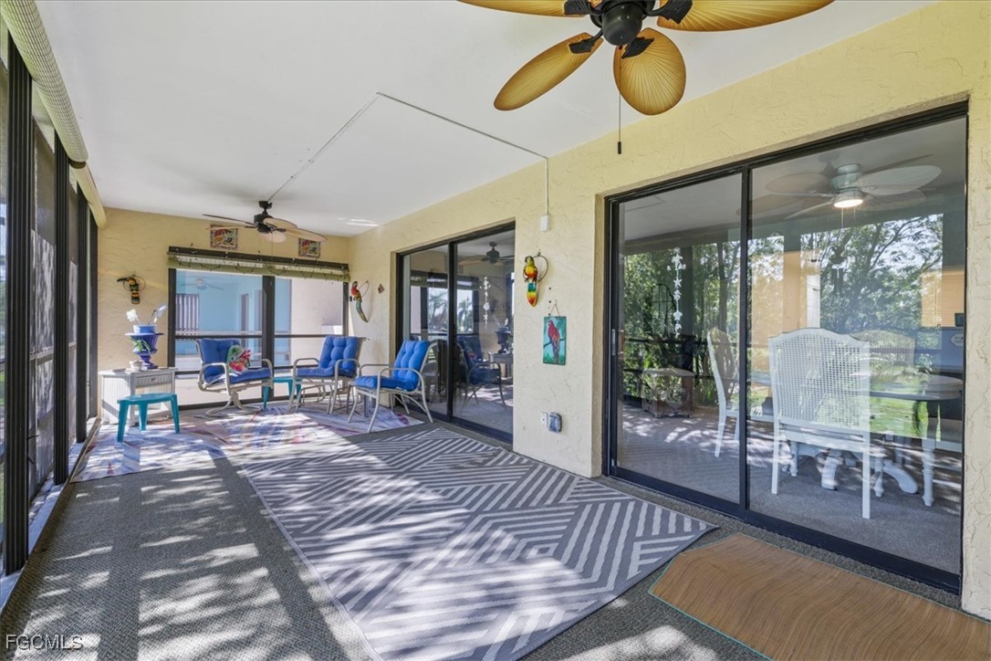 4728 Orange Grove Boulevard, Unit 8 North Fort Myers, FL 33903 - Photo 19 of 31 a view of a livingroom with furniture wooden floor and a rug