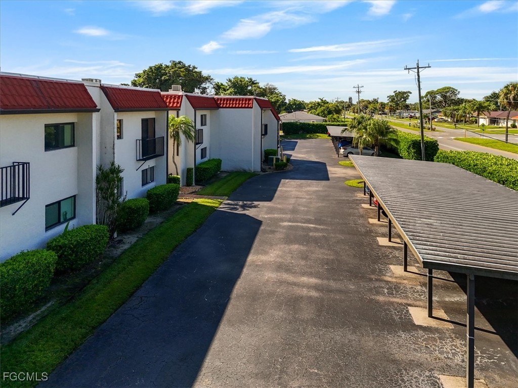 4728 Orange Grove Boulevard, Unit 8 North Fort Myers, FL 33903 - Photo 21 of 31 a view of a house with a yard