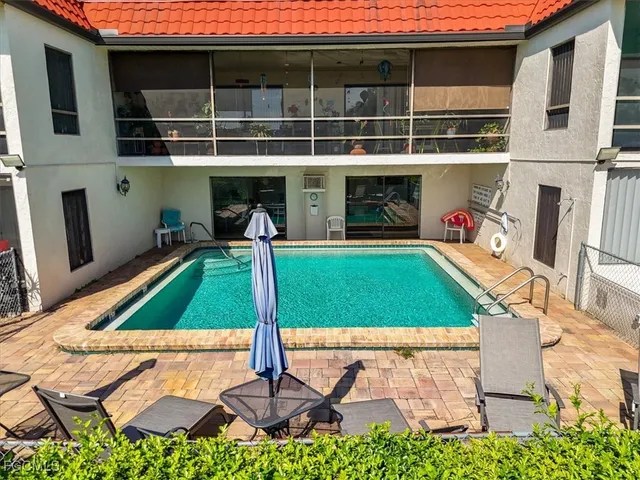 a view of an house with backyard space and swimming pool