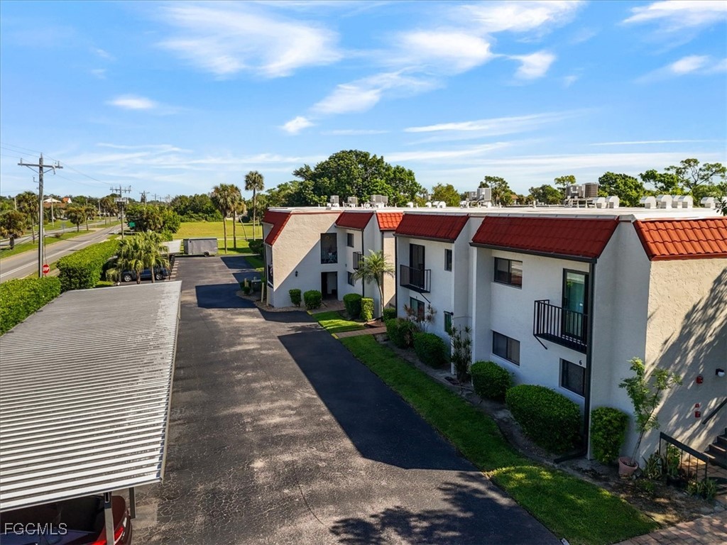 4728 Orange Grove Boulevard, Unit 8 North Fort Myers, FL 33903 - Photo 30 of 31 a view of a terrace with a garden