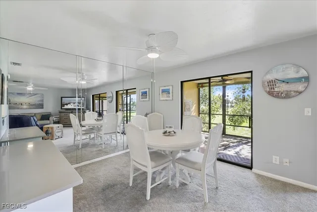 a dining room with furniture and a large window