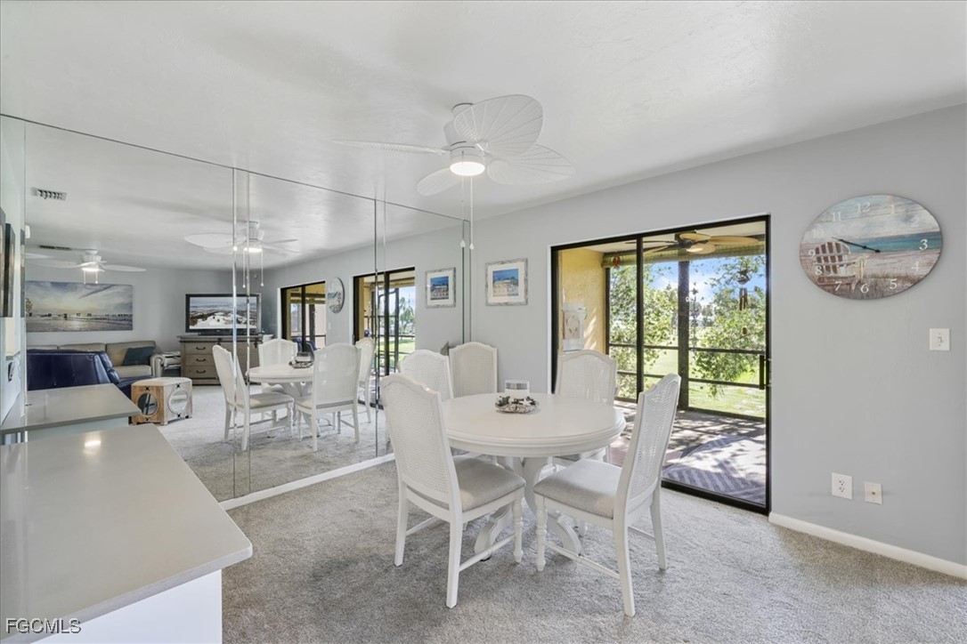 4728 Orange Grove Boulevard, Unit 8 North Fort Myers, FL 33903 - Photo 7 of 31 a dining room with furniture and a large window
