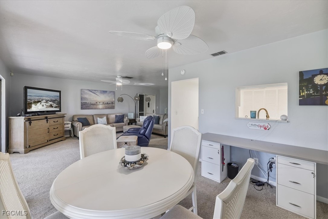 4728 Orange Grove Boulevard, Unit 8 North Fort Myers, FL 33903 - Photo 8 of 31 a dining room with furniture and window