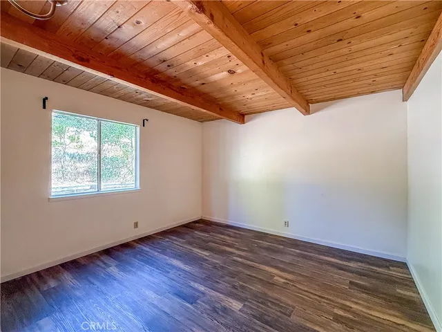 a view of room with window and wooden floor