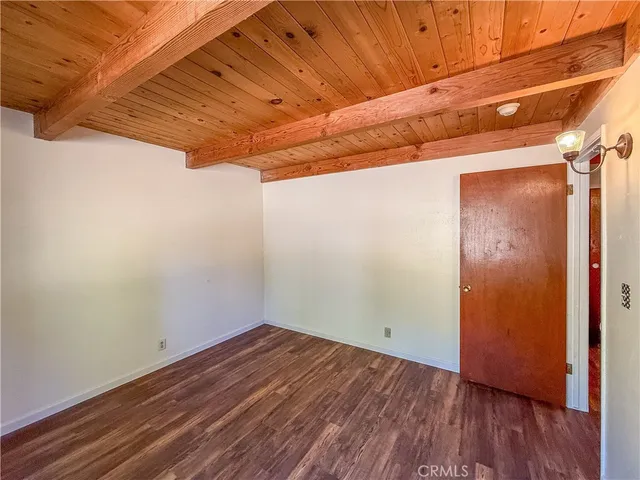 a view of a room with wooden floor