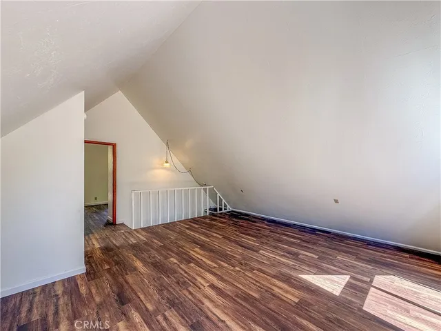 a view of a room with wooden floor
