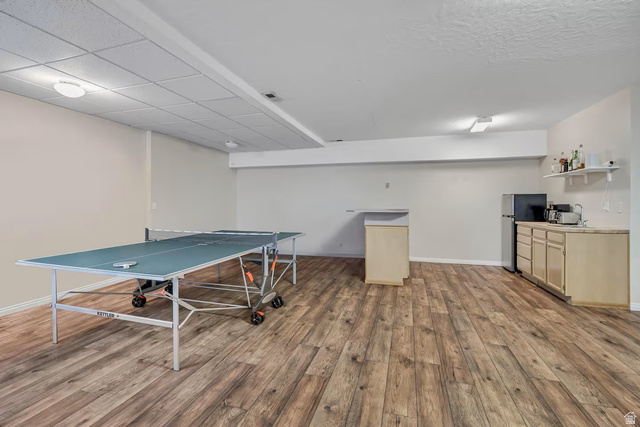 11789 Nicklaus Road Sandy, UT 84092 - Photo 50 of 58 Game room featuring light wood-style flooring and baseboards