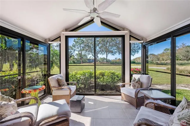 a living room with furniture and a floor to ceiling window