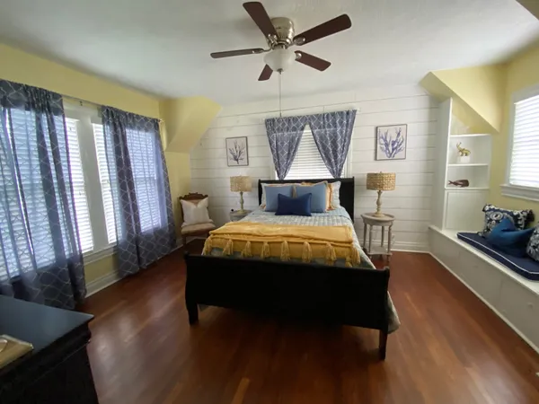 a bed sitting in a bedroom next to a window