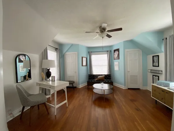 a living room with furniture a window and a chandelier