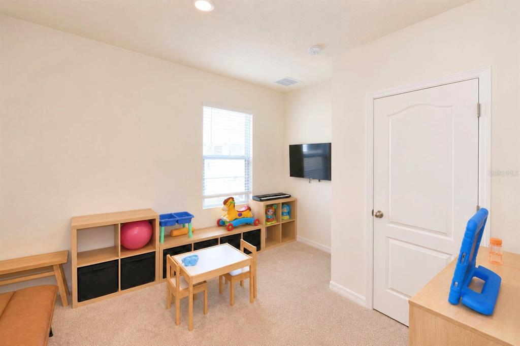 2839 Moulin Road Davenport, FL 33837 - Photo 26 of 75 a living room with furniture and a flat screen tv