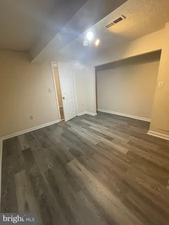 an empty room with wooden floor