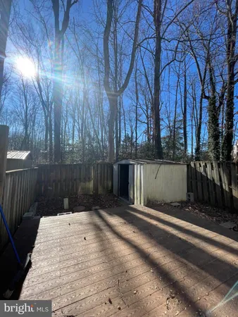 a view of backyard with wooden fence