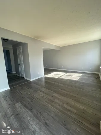 a view of an empty room and wooden floor