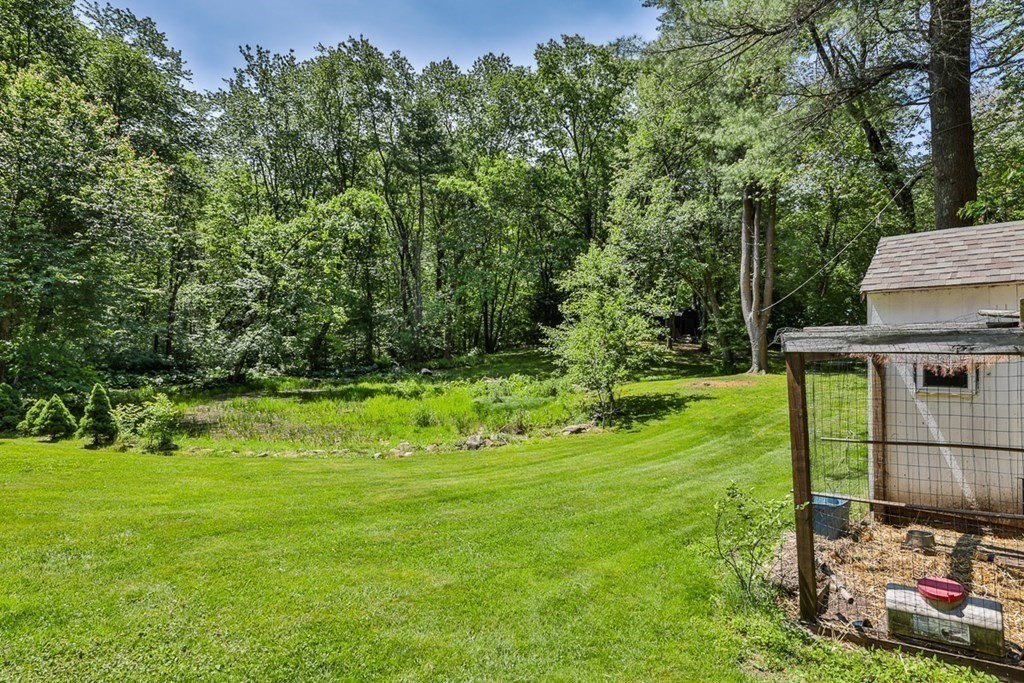 17 Highland Road Boxford, MA 01921 - Photo 38 of 42 a view of a backyard with potted plants and large trees