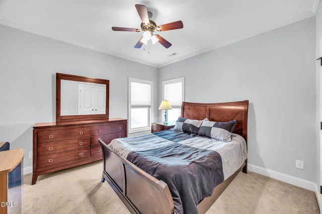 a bedroom with a large bed and a dresser