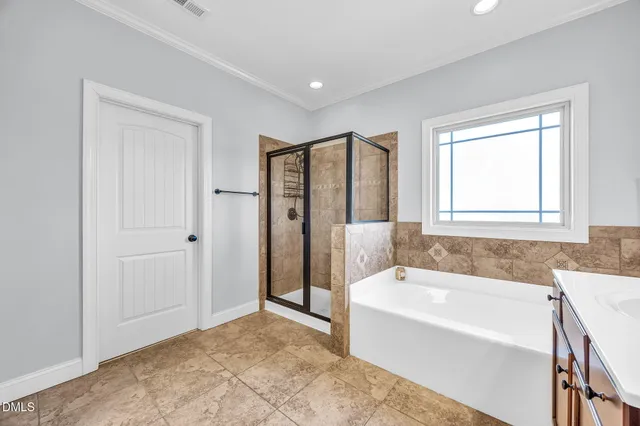a spacious bathroom with a bathtub and a shower