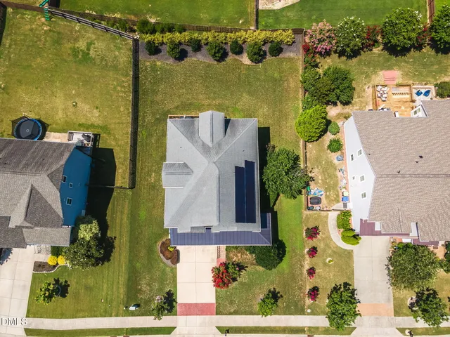 an aerial view of a house with a yard basket ball court and outdoor seating