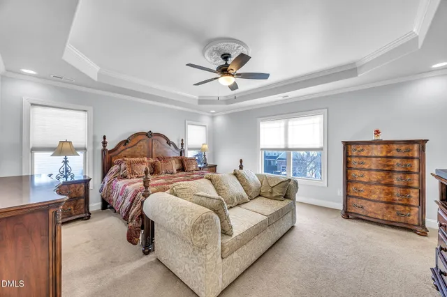 a bedroom with bed and a chandelier