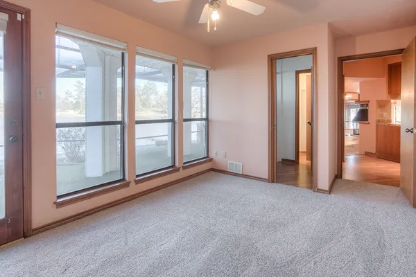 an empty room with windows and city view