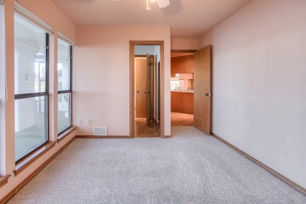 a view of empty room with a fireplace