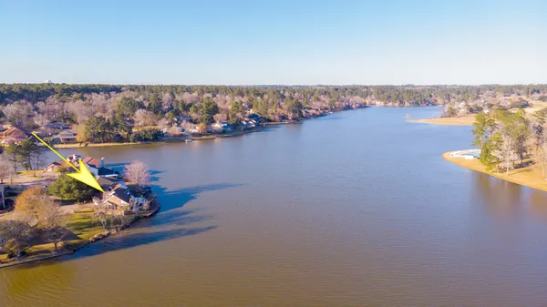 an ocean view with boats and trees in the background