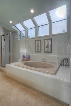a bathroom with a tub sink and mirror