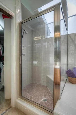 a bathroom with a glass shower door