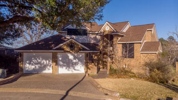 a view of a house with a yard and garage