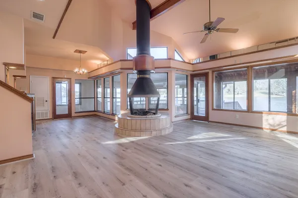 a view of empty room with wooden floor