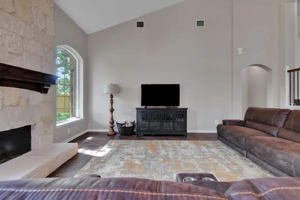 a living room with furniture a flat screen tv and a fireplace