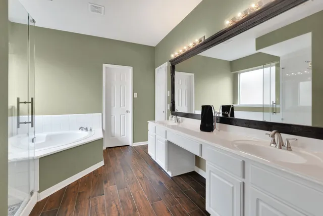 a bathroom with a double vanity sink and mirror