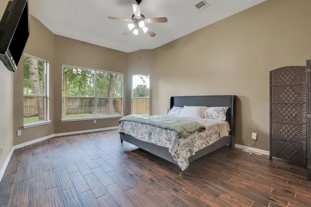 a bedroom with a large bed and a large window