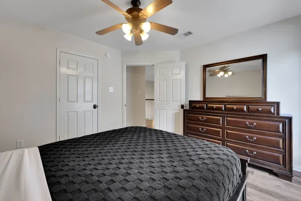 a bedroom with a bed and a chandelier
