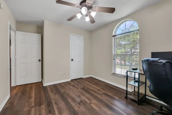 a view of a livingroom with hardwood floor and a ceiling fan